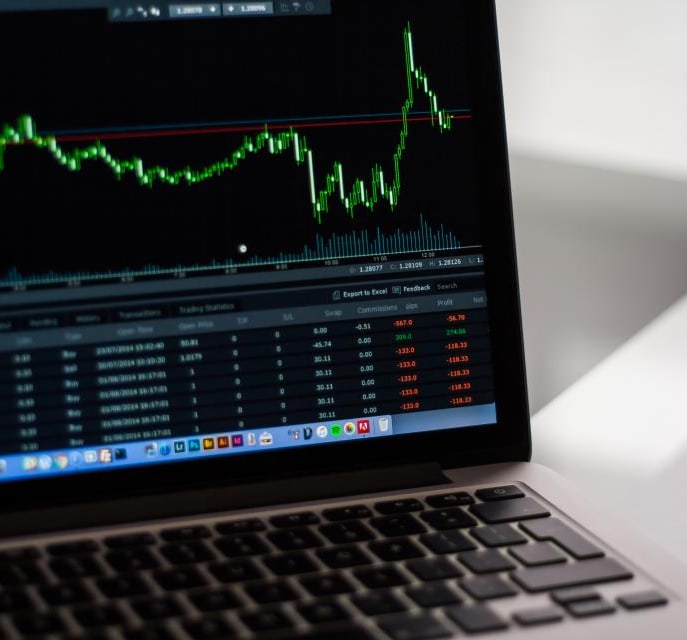 Stock market charts on a laptop