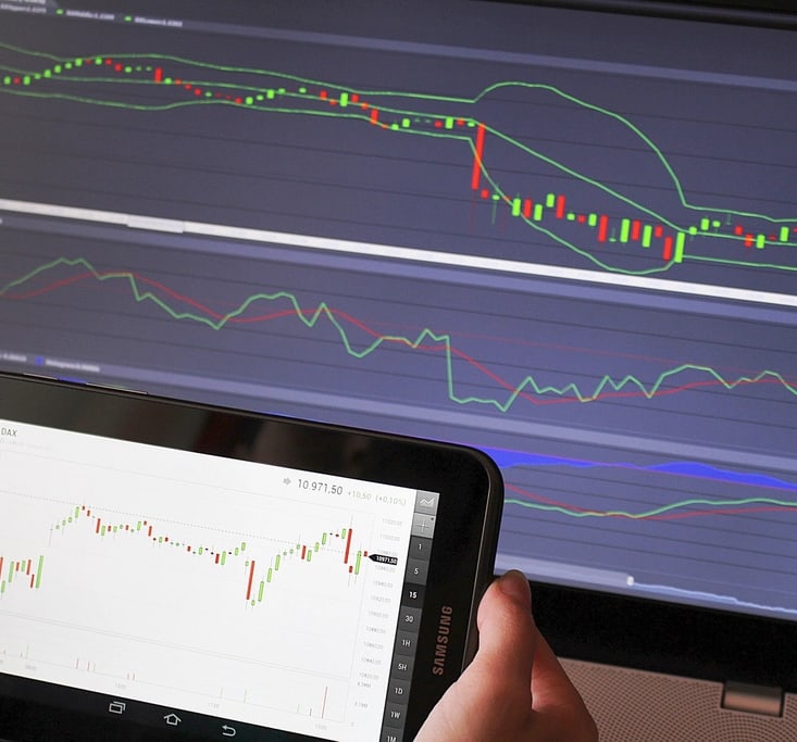 Trader checking market charts on a tablet